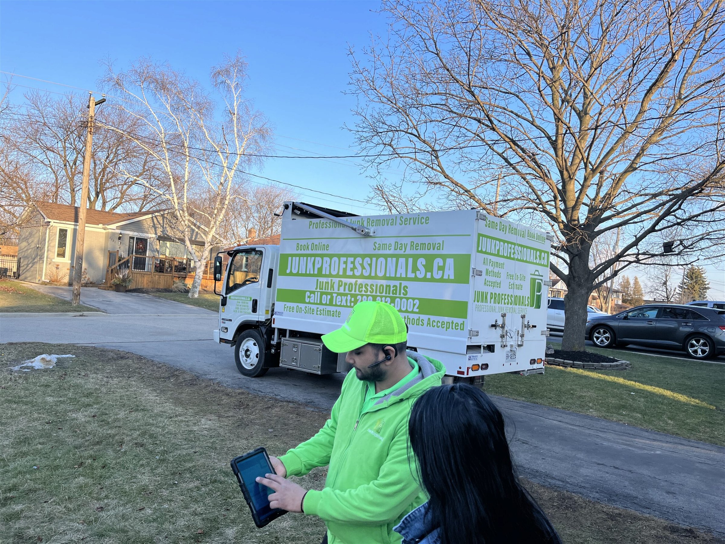 Junk Professionals team member showing price to a women for junk removal service.