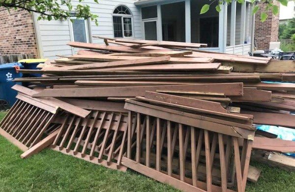 Demolished deck that need to be removed is to be picked by junk professionals