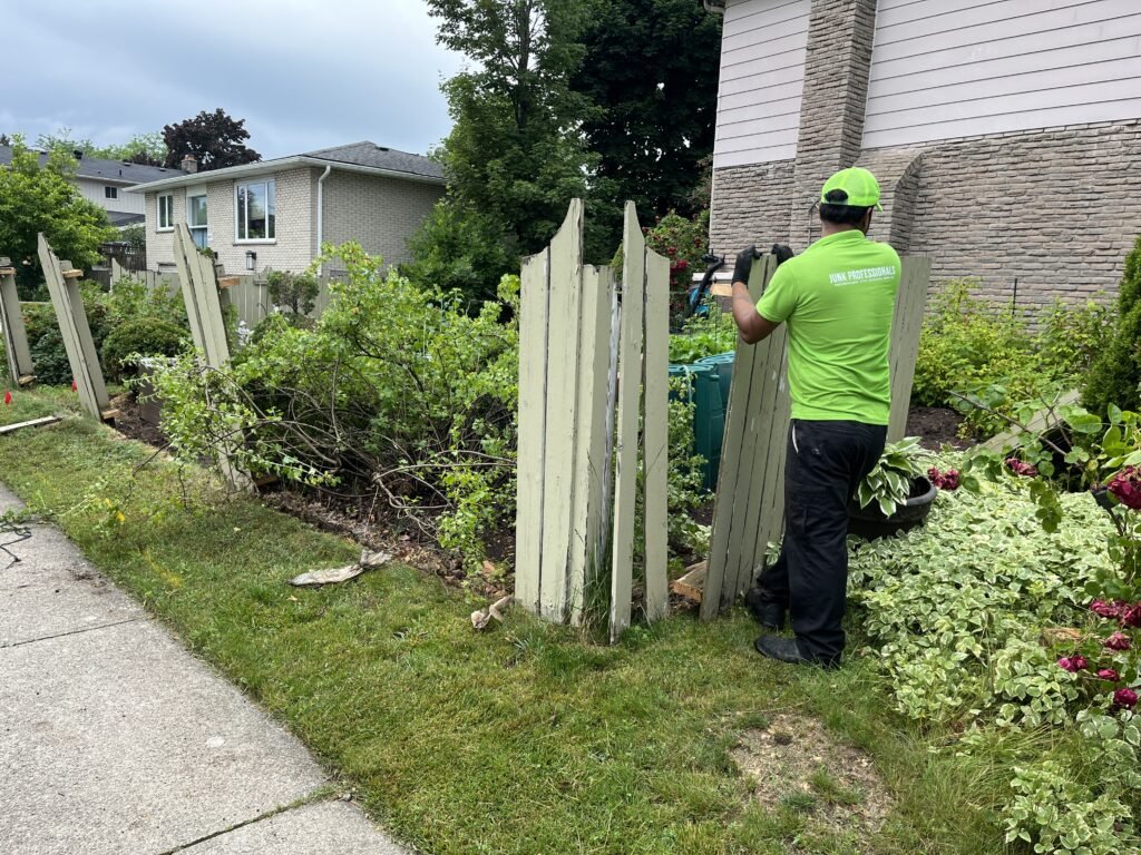 junk professionals employee removing fence in Toronto