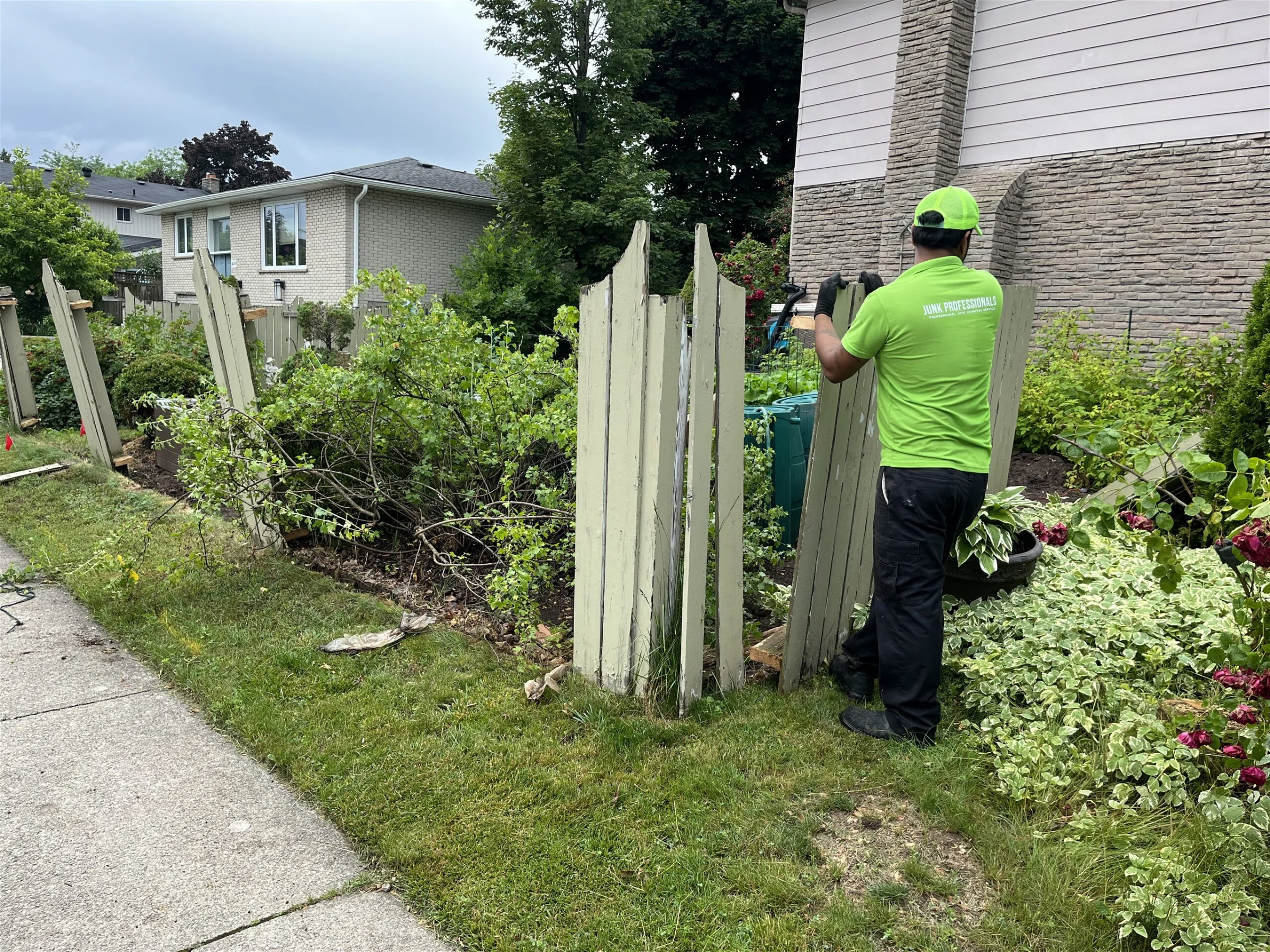 junk professionals employee removing fence