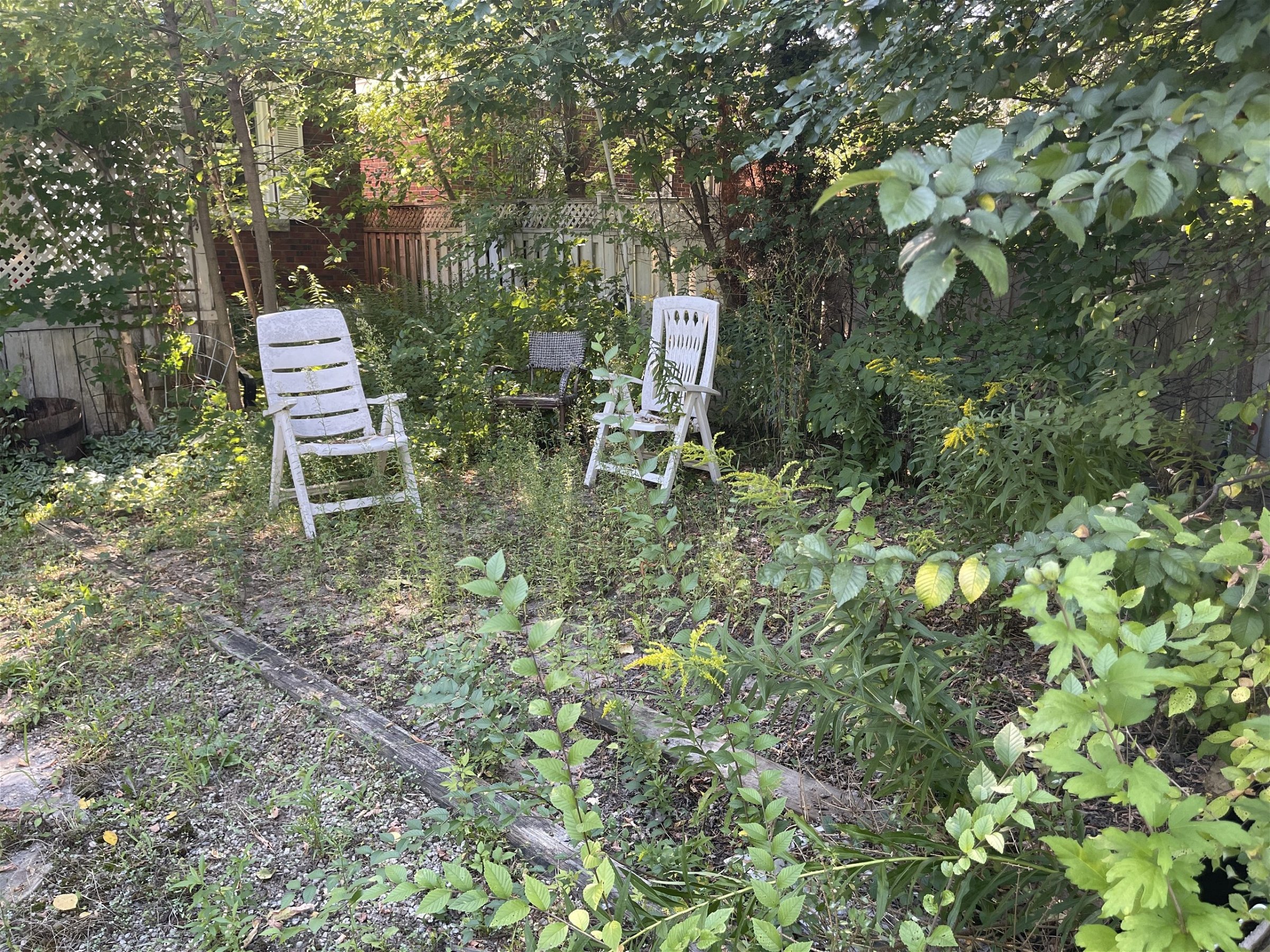 Unused debris and chairs lying on the yard that need to be removed